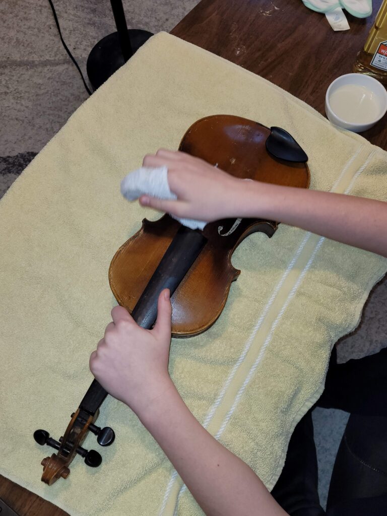 The Ellis Newton violin being cleaned